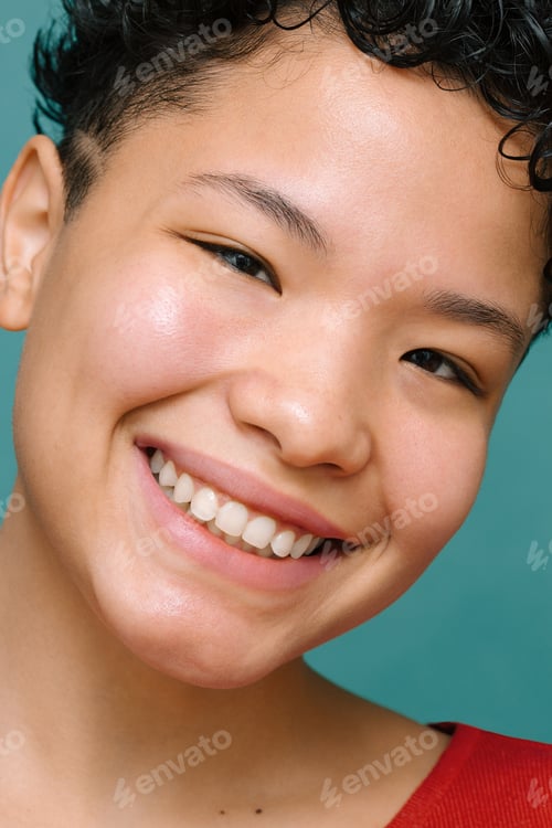 Preview: Portrait of young Latina woman with Asian eyes looking at the camera and smiling