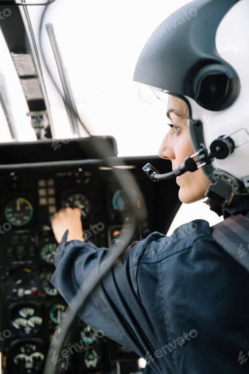 Preview: Attractive woman pilot sitting in the helicopter