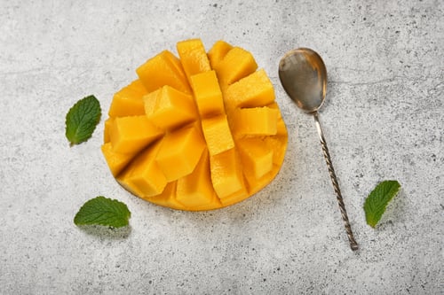 Preview: Serving fresh ripe cut mango on table