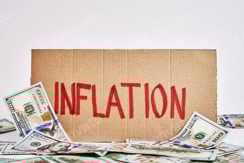 Preview: World inflation concept. Cardboard with word inflation and usd banknotes