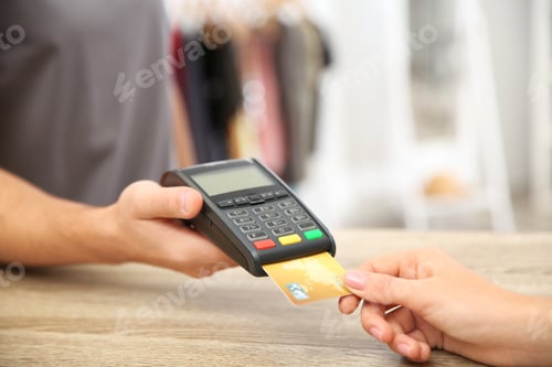 Preview: Woman using terminal for credit card payment in shop, closeup