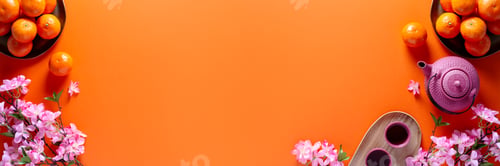 Preview: Chinese or lunar new year flat lay with mandarins, pink peach flower and tea set on orange
