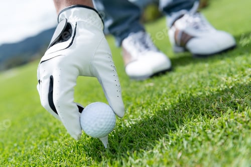 Preview: Man Placing Golf Ball At The Tee Box