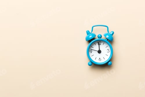 Preview: Alarm clock isolated on colored background with copy space top view