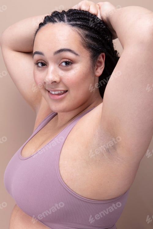 Preview: Studio portrait of smiling woman in purple bra