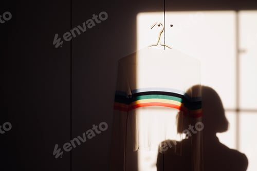 Preview: Rainbow sweater hanging on wall
