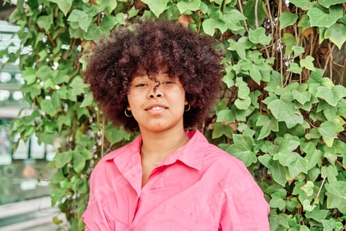 Preview: Woman Poses in Front of Green Ivy