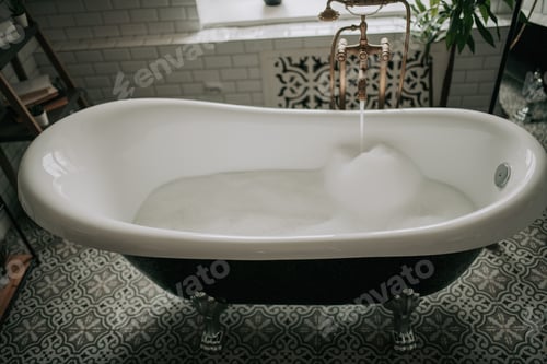 Preview: Luxury interior of eco style modern bathroom with oval bathtub and accessories at natural lighting