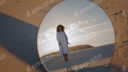 Preview: Woman dancing reflecting mirror at sand desert. African american girl performing