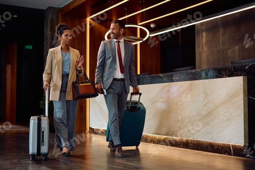 Preview: Happy coworkers arriving at the hotel during their business travel.