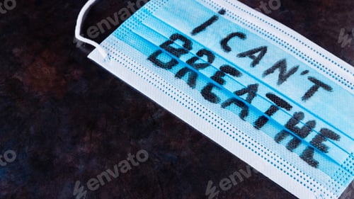 Preview: I Can'T Breathe On A Surgical Mask. Protective Face Mask With "I Can'T Breathe" On A Dark Background
