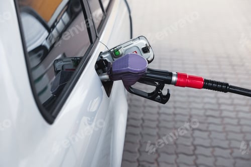 Preview: Refueling modern car at gas filling station, closeup