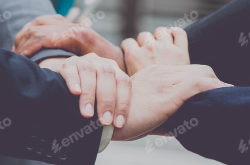 Preview: Business team standing hands together,