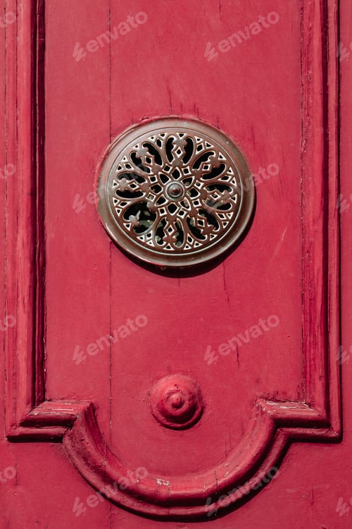 Preview: Bronze metal decoration on a red medieval wooden door in Spain, Europe