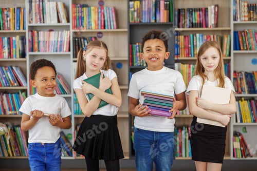 Preview: Four children holding stack of books in library. Multiethnic classmates having fun. Back to school.