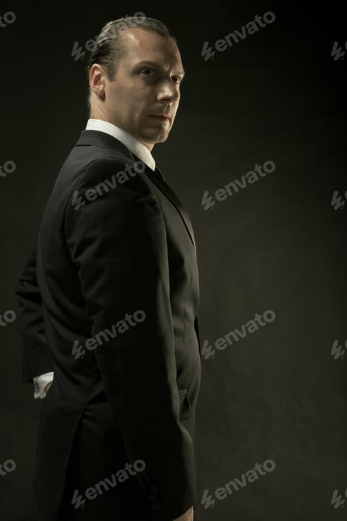 Preview: The Attractive Man In Black Suit On Dark Background
