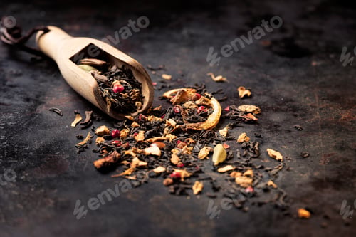 Preview: Dried Masala Chai Black Tea leaves on dark textured background banner.