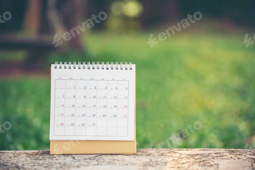 Preview: Desktop Calendar 2025 place on wooden office desk.