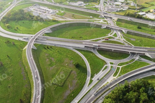Preview: Cars moving on transport road junction in city, aerial view