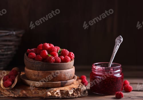 Preview: raspberry jam and fresh berries on wooden background
