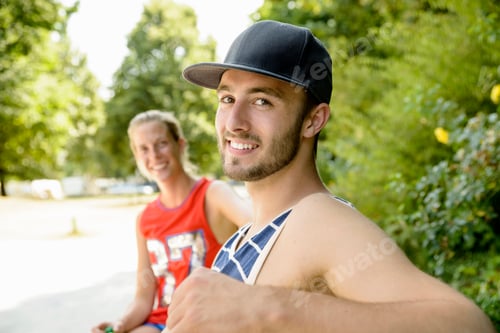 Preview: Portrait of young basketball players sitting on park bench