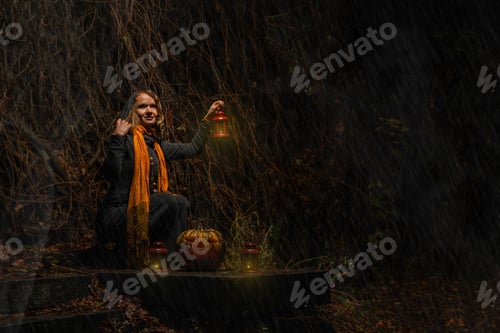 Preview: Happy Halloween! A pretty witch with a big pumpkin. Beautiful young in a witch costume