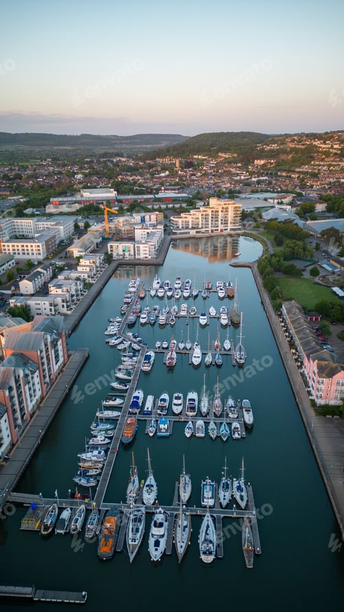 Preview: Scenic view of Portishead marina, with sailboats and buildings illuminated by the setting sun