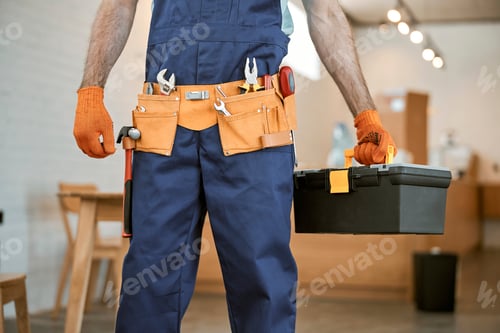 Preview: Male electrician in gloves holding tool box set