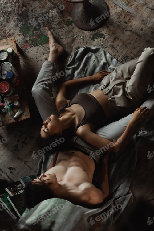 Preview: top view of passionate african american woman in top and pants lying with closed eyes near sexy