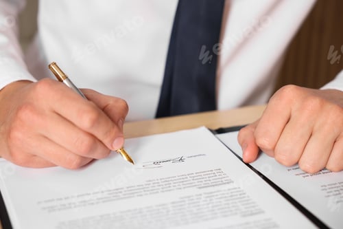 Preview: Man putting signature on document at table, closeup