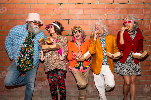 Preview: Group of happy senior friends with fancy clothing having party in the night