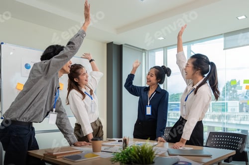 Preview: Business team celebrate corporate victory together in office, laughing and rejoicing, smiling