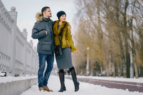 Preview: happy couple walking through the park on a sunny winter day
