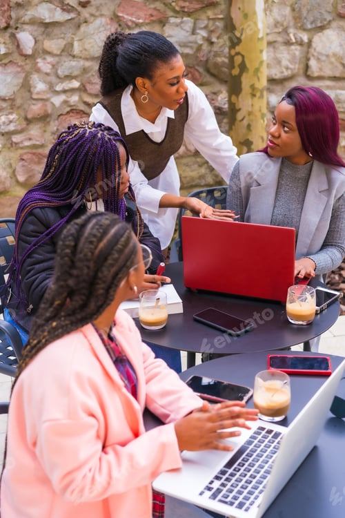 Preview: Young businesswomen of black ethnicity. In a business meeting in a cafeteria