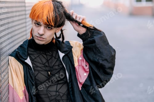 Preview: Close-up of boy with black and orange hair looking at camera.