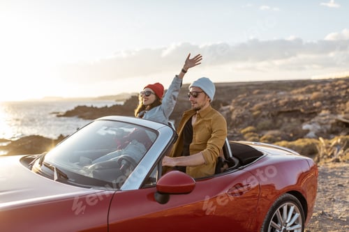 Preview: Lovely couple driving a cabriolet near the ocean