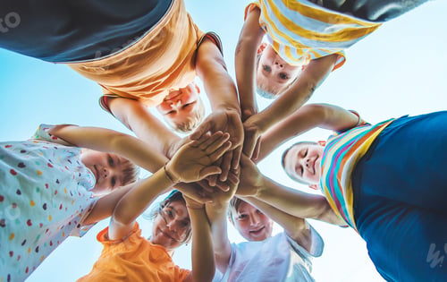 Preview: Children are playing with their hands clasped together. Selective focus.