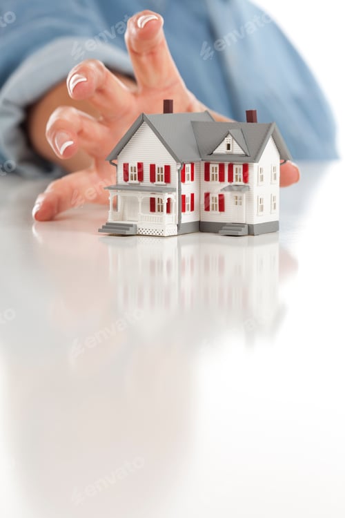 Preview: Womans Hand Reaching for Model House on White