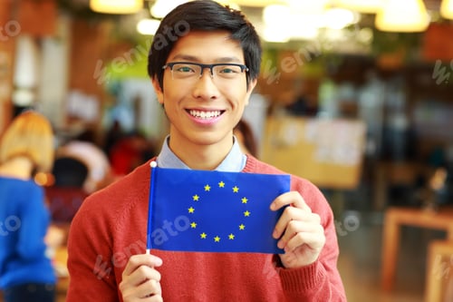 Preview: Happy Young Asian Student Holding Flag Of Europe Union