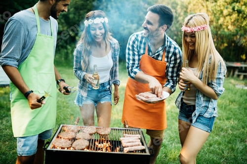 Preview: Group of friends making barbecue in the nature
