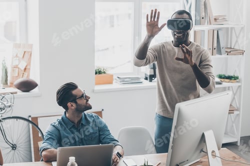 Innovative Colleagues Explore Virtual Reality in Modern Office