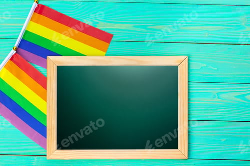 Preview: Bright rainbow gay flag on wooden background and blank space