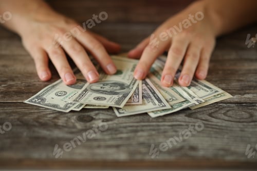 Preview: A woman counting money.