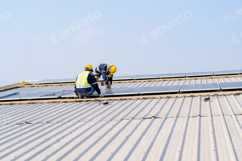 Preview: workers installing solar panels, for efficient energy on rooftop