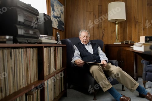 Preview: Elderly man taking a peaceful nap in a cozy room filled with records and books.