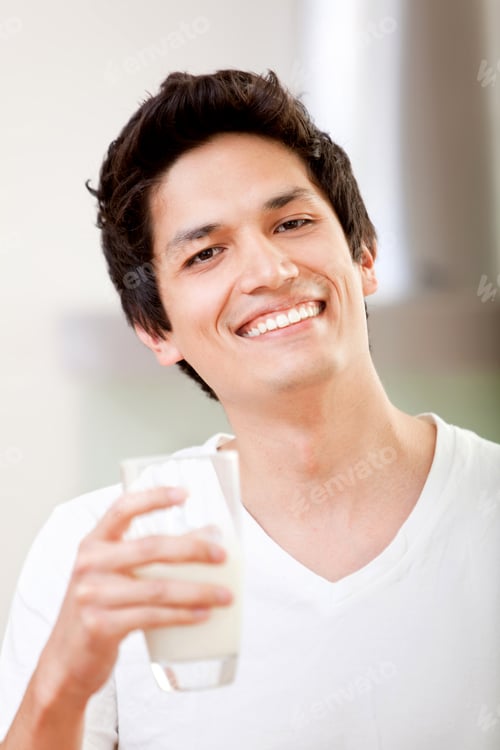 Preview: Handsome Guy Drinking A Glass Of Milk At Home