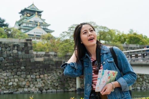 Preview: girl holding map enjoying viewing Osaka castle