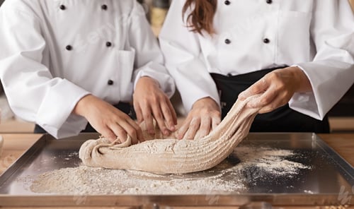Preview: Crop bakers kneading dough together