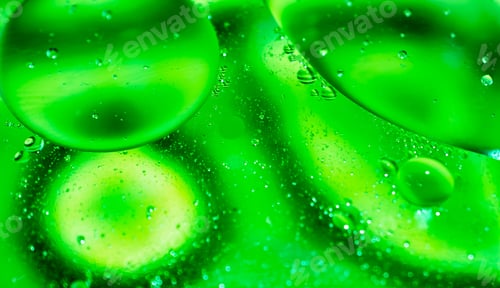 Preview: oil drops on water on green background