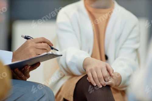 Preview: Therapist Holding Clipboard and Taking Notes